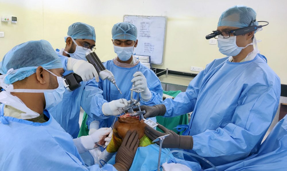 Surgeons performing a knee replacement operation